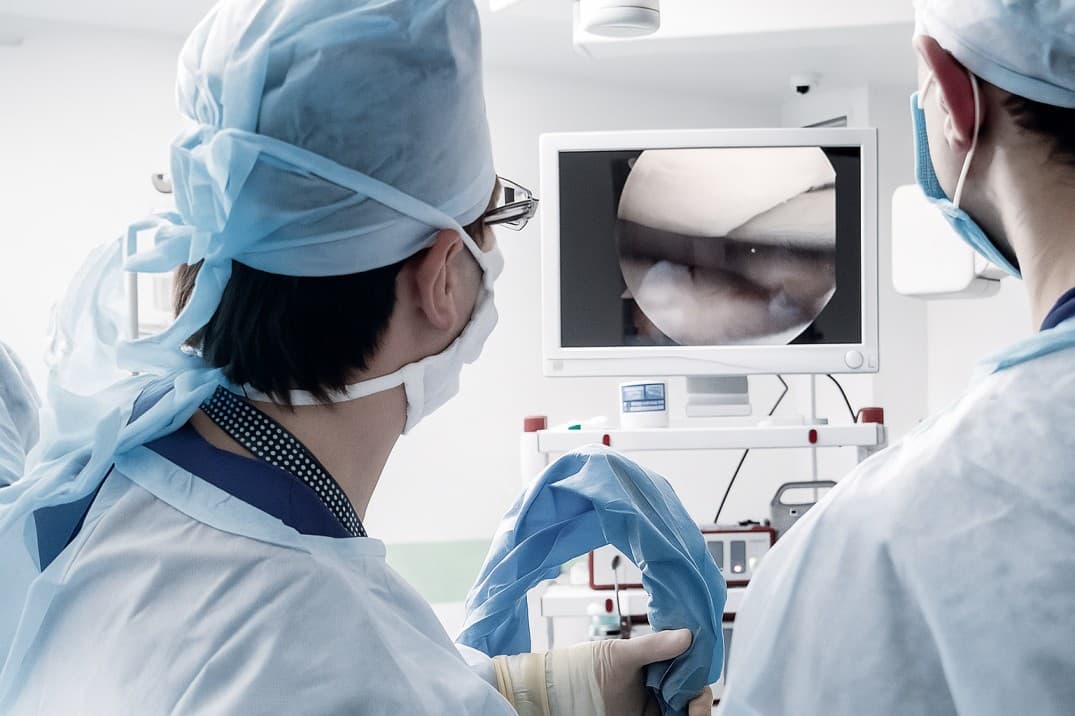 Clinical team viewing an arthroscopic cartilage procedure